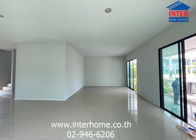 Spacious living area with large windows and sliding doors