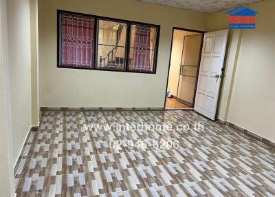 Main living space with tiled flooring and window