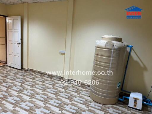 Utility room with water tank and tiled flooring