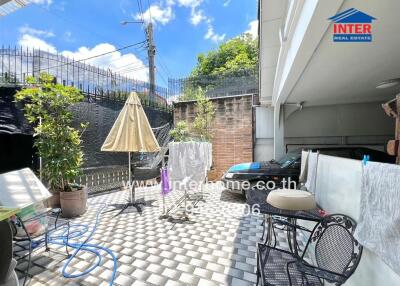 Outdoor patio area with seating and plants