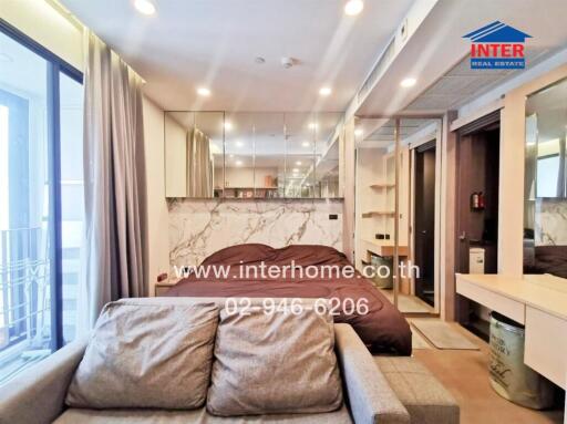 Modern living area with sofa and adjacent bedroom