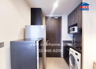 Modern kitchen with appliances and laundry machine