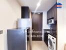 Modern kitchen with appliances and laundry machine