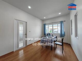 Bright dining room with a large window and modern furnishings