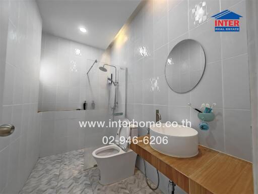 Modern bathroom with shower, toilet, and sink