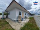 Single-story house with white walls and yard