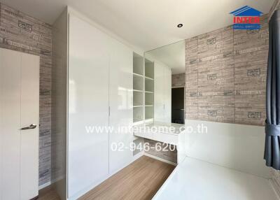 Modern bedroom with built-in wardrobe and wooden floor