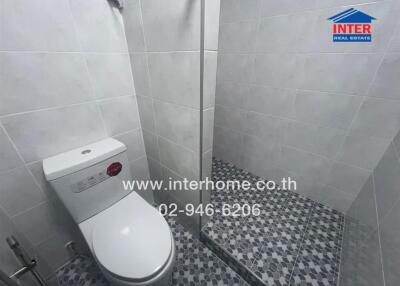 Modern bathroom with tiled walls and shower area