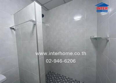 Tiled bathroom with glass shower partition