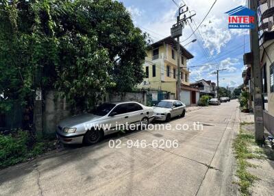 Street view with parked cars in front of residential buildings