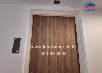 Door with property number and real estate agency contact information