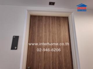 Door with property number and real estate agency contact information