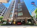 High-rise residential building with multiple floors and parking area