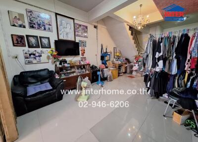 Living room with leather sofas, TV, and storage space