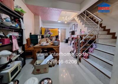 Spacious living area with a dining table and staircase