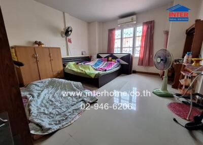 Bedroom with two beds, dresser, and other furnishings