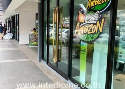 Cafe Amazon storefront with glass doors and colorful signage