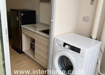 Laundry area with washing machine and small kitchenette