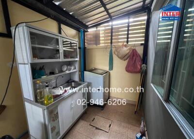 Small kitchen with cabinetry and washing machine