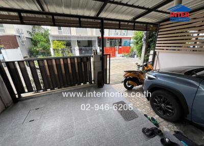 Covered garage area with a car and motorbike