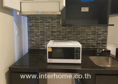 Compact kitchen with microwave and sink