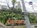 Entrance of a building complex with trees and power lines