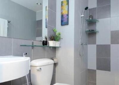 Modern bathroom with shower, sink, and toilet