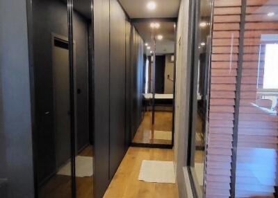 Modern hallway with wooden floors and large mirrored closets