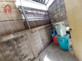 Small storage area with bins and concrete walls