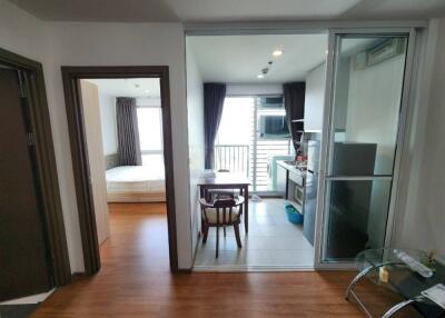 View of living area leading to kitchen and bedroom