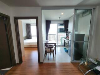 View of living area leading to kitchen and bedroom