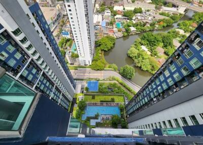 Aerial view of high-rise buildings with outdoor pool and cityscape.