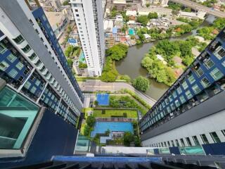 Aerial view of high-rise buildings with outdoor pool and cityscape.