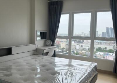 Bedroom with a large window and city view