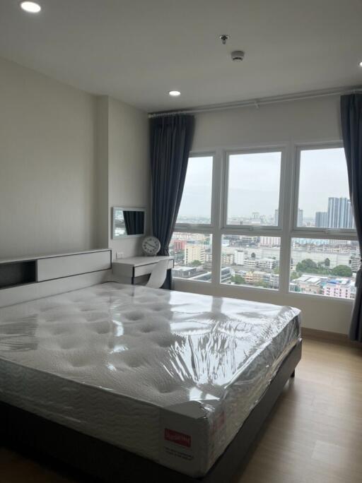 Bedroom with a large window and city view