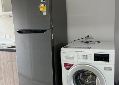 Kitchen with refrigerator and washing machine