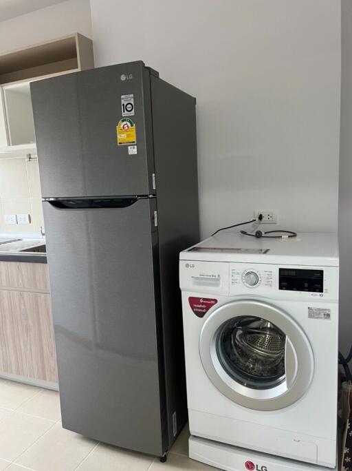 Kitchen with refrigerator and washing machine