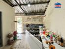 A spacious kitchen with a metal ceiling, white walls, and ample counter space.