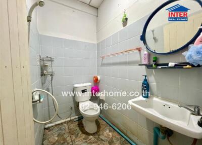 Bathroom with toilet, sink, and shower