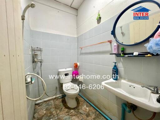 Bathroom with toilet, sink, and shower