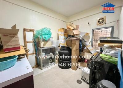 Cluttered storage room with boxes and various items