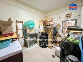 Cluttered storage room with boxes and various items