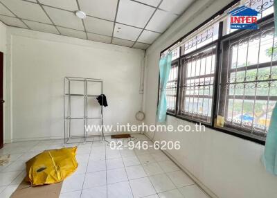 Unfurnished bedroom with tiled floor and large windows