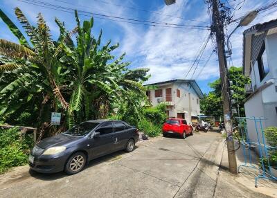 Street view with parked cars and residential buildings