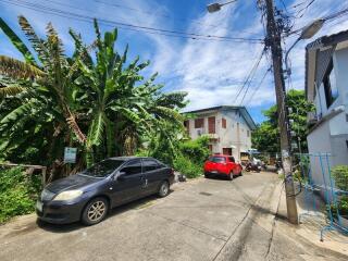 Street view with parked cars and residential buildings