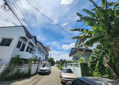 Street view of neighborhood with houses and cars