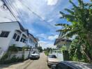 Street view of neighborhood with houses and cars