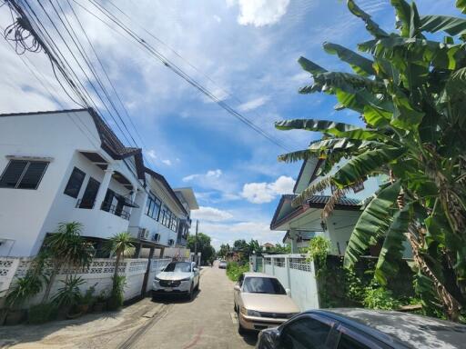 Street view of neighborhood with houses and cars