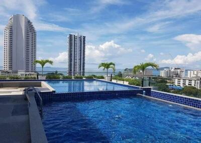 view of a rooftop pool with cityscape in the background