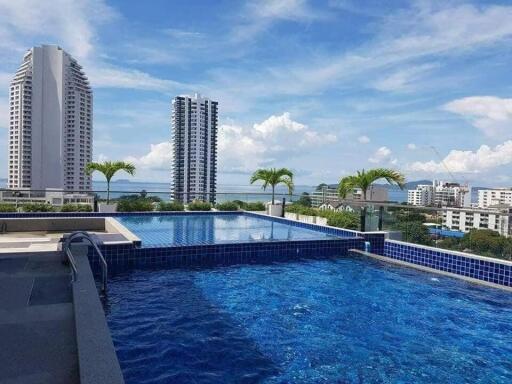 view of a rooftop pool with cityscape in the background